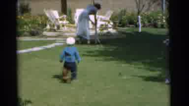 Chatham New Jersey (1951): Small Brown Pet Weiner Dog Running Up To A Little Boy