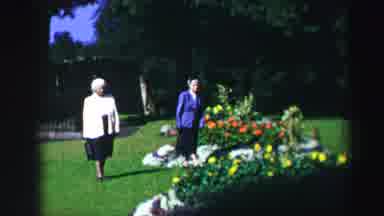 Edinbourgh Scotland (1952): Two Elderly Women Walking Through A Garden With
