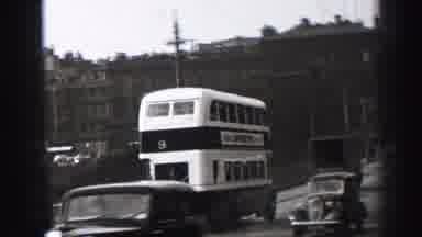 EDINBOURGH SCOTLAND-1952: A Vintage Double Decker Bus Driving Down The Street To