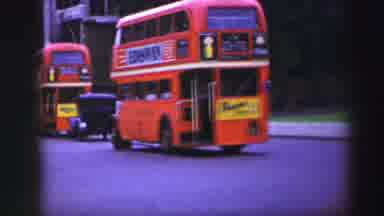 EDINBOURGH SCOTLAND-1952: Red Double-Decker Bus and Mounted Soldier on City Street