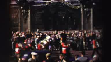 Edinbourgh Scotland (1952): Royal Guards March Through A City Street During A