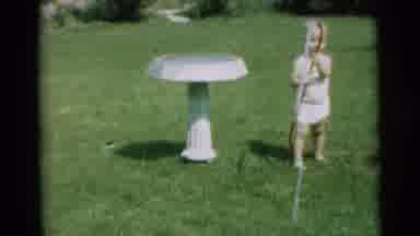 Pennington New Jersey-1954: Child Watering Birdbath in Backyard