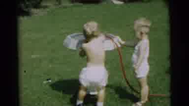 Pennington New Jersey-1954: Two Children Playing Outside With A Hose By A Birdbath