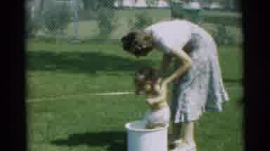 Pennington New Jersey (1954): A Mother Tries To Put Her Diapered Baby In A White
