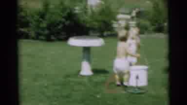 Pennington New Jersey (1954): Two Children Play With A Water Bucket And Hose In A