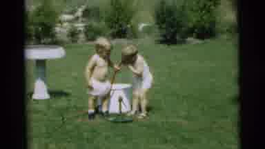 Pennington New Jersey (1954): Two Toddlers Drink The Water From A Hosepipe In The