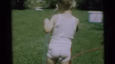 Pennington New Jersey (1954): A Small Child Playing With A Hose In The Backyard