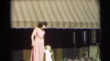 Pennington New Jersey (1954): A Woman In A Dress Walks Her Toddler In The Grass