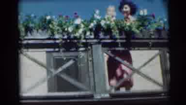 Pennington New Jersey (1954): A Balcony With Full Of Flowers And A Lady Holding An