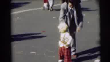 Pennington New Jersey (1954): Man Wearing Grey Suit Helps Toddler Wearing Red