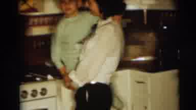Pennington New Jersey (1954): A Lady Holding A Kid Standing In The Kitchen Near