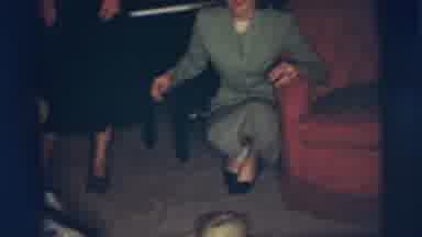 Pennington New Jersey (1955): Woman Wearing Green Suit Watches Boy Ride Black And