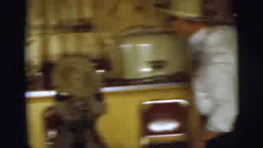 Pennington New Jersey (1955): A Man In A Hat And Fake Nose Glasses Puts A Hat On A