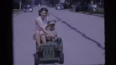 Pennington New Jersey (1955): Little Boy Driving Toy Army Jeep Down A Street With