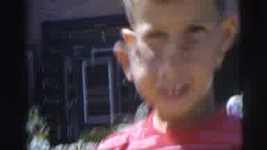 Pennington New Jersey (1955): Gap-Toothed Boy Smiles And Looks Down At Red Striped
