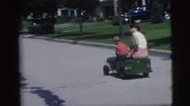 Pennington New Jersey (1955): Mother And Child Ride Green Wagon Down Street Near
