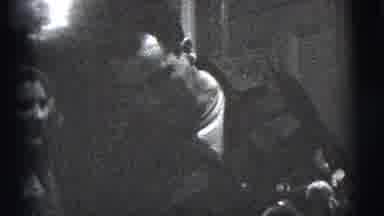 New York City (1956): Man Smoking Cigarette While Sitting On A Couch