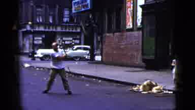 New York City (1956): Man With A Metal Bar Approaching Two Men And A Group Of