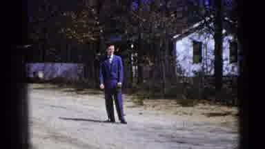 New York City (1956): A Man In A Suit Standing In A Road