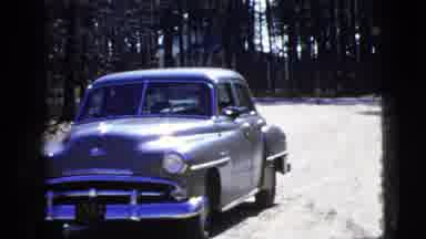 New York City (1956): The Car Driver Drives The Car Slowly In The Sand Road And