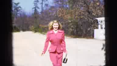 New York City (1956): Blonde Lady In A Pink Suit Skipping Down Road Toward Man In