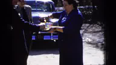 New York City (1956): A Lady Standing Up Holding A Tray Full Of Glasses Pouring