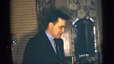 New York City (1956): A Middle Aged Man Wearing A Suit And Tie Is Talking In A