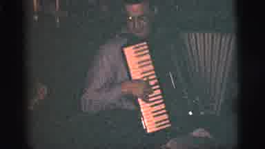 New York City (1956): A Man Playing A Musical Instrument Indoor While Enjoying The