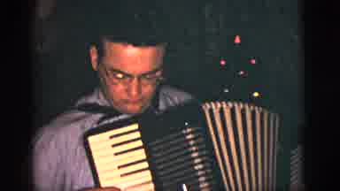 New York City (1956): A Man Playing The Accordion While Others Watch