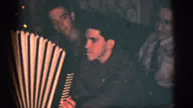 New York City (1956): Man Playing Harmonica At A House Party