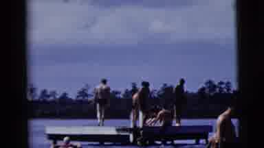 New York City (1958): Men Enjoying The Lake Standing On A Dock In Speedo Swimwear