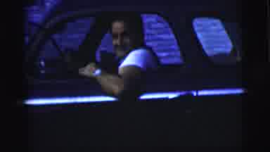New York City (1958): Man Driving Down The Street While Looking Out Of His Rolled