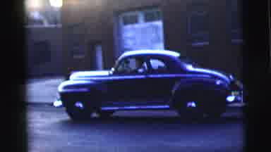 New York City (1958): A Man Driving A Vintage Car