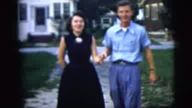 New York City (1958): Man And Woman Hold Hands As They Walk Up Their Driveway For