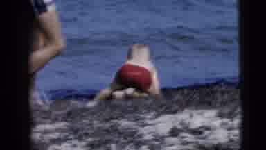 New York City (1958): Man Close To Child Playing By The Beach While Women Is