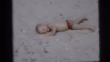 New York City (1958): Smiling Baby On The Beach Rolling And Having Fun On A Nice