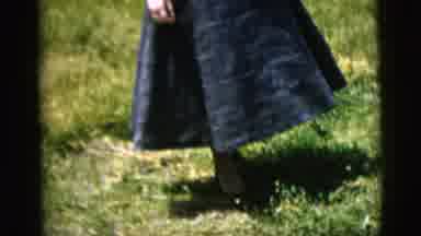 New York City (1958): Woman In Blue Dress Smiling Coyly While Walking Forward