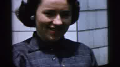 New York City (1958): Happy Woman Pinning Corsage On Her Left Shoulder During The