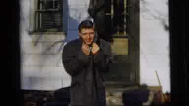 New York City (1958): A Man Is Standing Outside Wearing A Dark Coat And Smiling