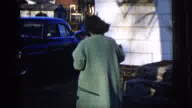 New York City (1958): Woman In Long Coat Walks Briskly To Towards Car Turns Around