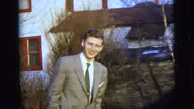 New York City (1958): Young Man Dressed In Suit Standing Outside Home Pots His
