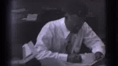 Saint Louis Missouri (1959): A Man At A Desk Writes On Paper And Then Erases