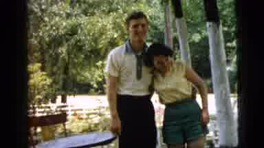 Camden New Jersey (1961): Man And Woman Wearing Yellow Shirts Stand Next To Small