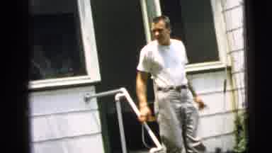 Camden New Jersey (1961): A Man In A White Shirt Is Walking Out Of The House