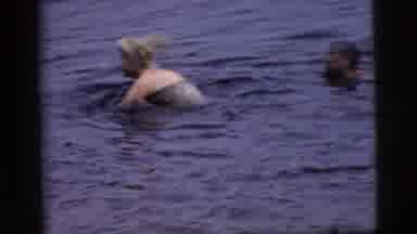 Camden New Jersey (1961): Woman Wearing White Swimwear Stands Up In Water On A