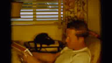 Clarkdale Arizona (1961): Man Wearing White Shirt Looks At Red And White Box