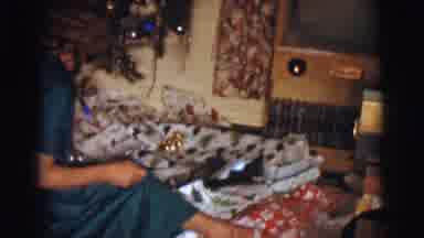 Clarkdale Arizona (1961): Woman Sitting Down By A Christmas Tree Handing Out