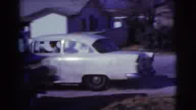 Clarkdale Arizona (1961): A White Car Driving Buy Some White House