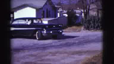 Clarkdale Arizona (1961): Person Parks Black And White Car Next To Brown Car On A