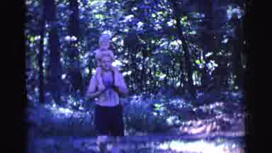 Clarkdale Arizona (1961): Man Walking Near A Forest While Carrying A Child On His